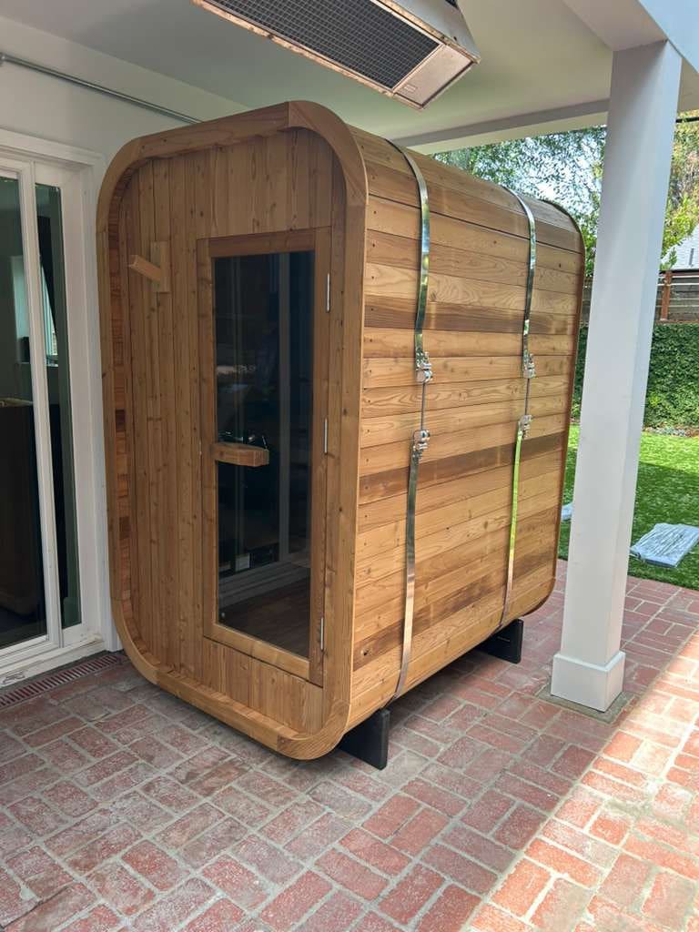 Cedar cube sauna on covered brick patio