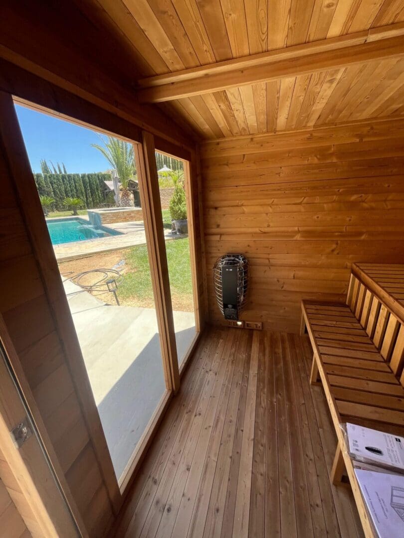 Sauna interior with pool view and wood benches